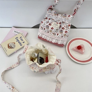 Flat lay of Korean style drawstring bucket bags with floral and cartoon print details