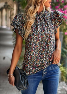 Detail of floral print blouse featuring ruffle sleeves and stand-up collar design