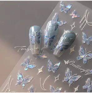 Macro detail of laser butterfly nail art stickers with iridescent blue holographic effects