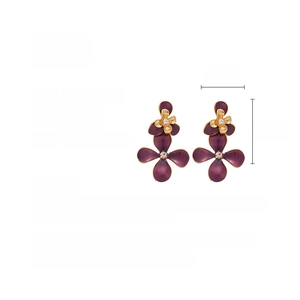Detailed view of vintage purple flower earrings with gold petals and central rhinestone