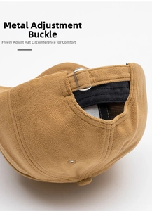 Detail of brown faux suede baseball cap with adjustable silver metal buckle and strap