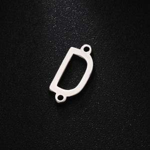 Detailed macro view of a polished stainless steel D-letter pendant with double rings
