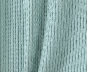 Dettaglio macro del tessuto a maglia a coste verde chiaro con trama e drappeggio
