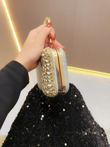 Elegant silver rhinestone evening clutch bag with crystal accents and round metal handle