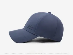 Detail view of navy blue baseball cap with mountain embroidery and fabric texture