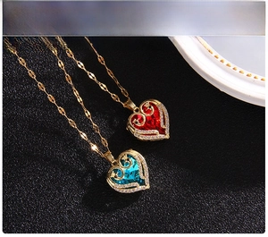 Detailed macro view of heart crystal pendants with gold chains on a black textured base