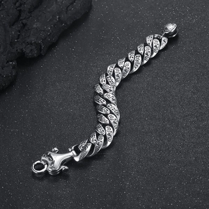 Macro shot of punk style stainless steel bracelet with engraved Egyptian hieroglyphs