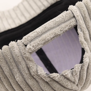 Detail of light gray corduroy baseball cap showing rear opening and soft fleece lining