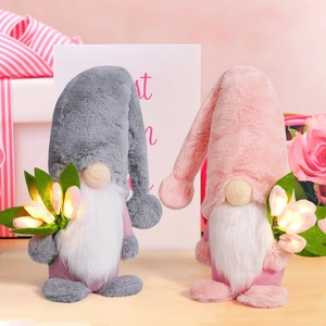 Detail of plush gnome dolls with glowing LED tulips in a gift box arrangement