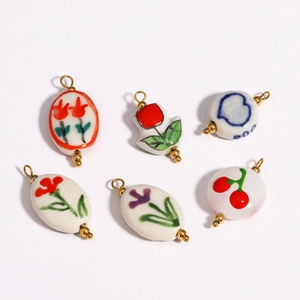 Set of 6 ceramic pendant necklaces with floral and heart patterns plated in 18K gold