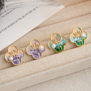 Oil painting style four-leaf clover stud earrings with natural pearls on jewelry tray
