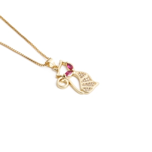 Detailed view of a golden fox necklace pendant with red gem eyes and crystal accents