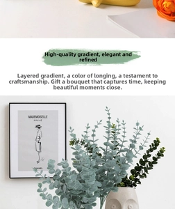 Artificial eucalyptus leaves in a minimalist face-shaped ceramic vase for home decoration