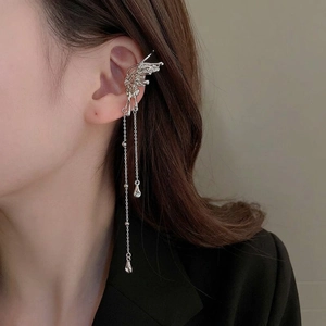 Elegant silver butterfly ear cuff with tassel pendants and teardrop rhinestones on model