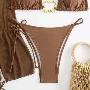 Detail of chocolate bikini set with gold rings and matching mesh beach cover-up skirt