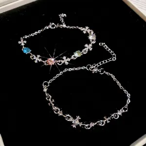 Sparkling cross pendant bracelet with colorful zircon stones in a jewelry box