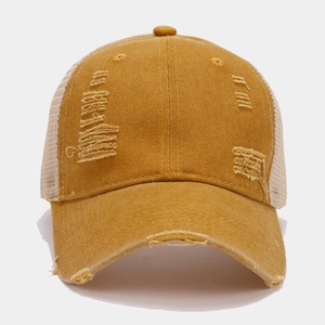 Detailed macro view of retro distressed baseball cap with breathable mesh and ripped fabric