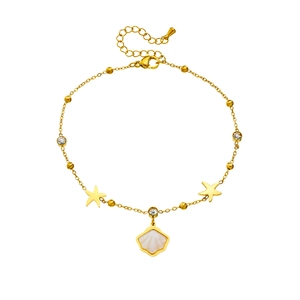 Gold stainless steel anklet with starfish, seashell, and rhinestone charms on white background