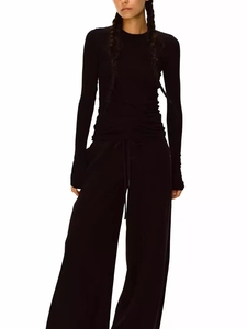 Detail view of the soft knitted texture and slim fit of this black long sleeve two-piece set