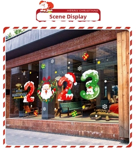 Detailed Christmas 2023 window stickers with Santa and snowflakes on a glass storefront