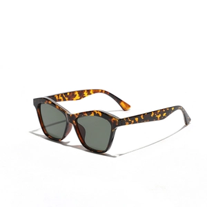 Retro tortoise shell cat-eye sunglasses with dark green lenses and a thick vintage frame
