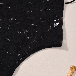 Close-up of black floral lace stitching and delicate embroidery on the bodysuit