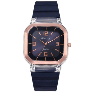 Detailed view of square rose gold watch case with blue dial and textured silicone strap
