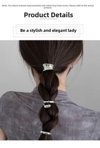 Detail of silver hammered metal hair clips styled on a dark brown braided ponytail