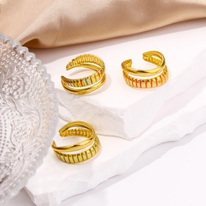 Detailed macro of three-piece 18K gold plated ring set with colorful enamel stripes