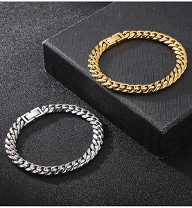 Close-up of gold and silver Cuban chain bracelets showing polished and matte textures