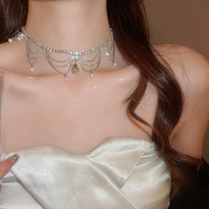 Detail of elegant fringe choker necklace with sparkling rhinestones and pearl tassels