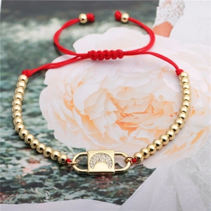 Adjustable red string bracelet with gold beads and a moon-shaped zircon lock pendant