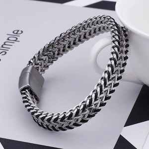 Close-up of a silver and black braided stainless steel bracelet with magnetic clasp