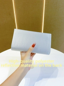 Detail showing the premium reflective polyester fabric on this silver evening clutch bag