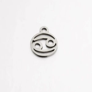 Macro detail of a mirror-polished stainless steel Cancer zodiac charm with a top loop