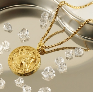 Detailed close-up of 18k gold horse head 3D relief pendant with Greek key border and box chain