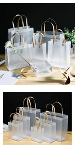 Frosted semi-transparent PP gift bags with golden braided handles and waterproof texture