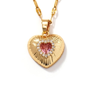 Elegant heart pendant necklace with pink gemstone and gold radial pattern engraving