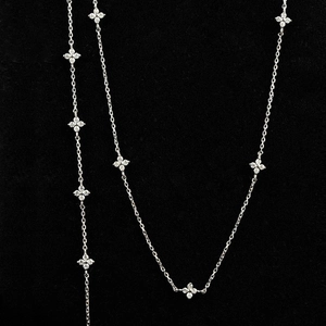 Detail view of silver clover necklace and bracelet set with micro-paved zirconia stones