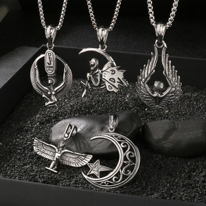 Detailed close-up of five vintage silver Egyptian goddess and angel wing pendants