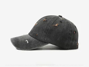 Detailed close-up of vintage washed grey cotton baseball cap with colorful dog embroidery