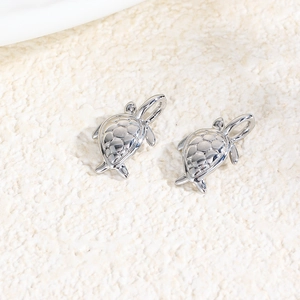 Macro shot of silver metal sea turtle charms for DIY handmade necklace and bracelet making