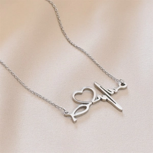 Close-up of titanium steel necklace featuring a heart and heartbeat pendant in silver finish.
