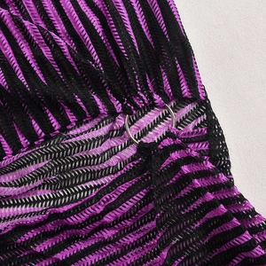 Close-up of purple and black mesh knit fabric with a silver metal ring connector detail