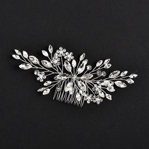 Detail view of crystal and pearl bridal hair comb with elegant floral silver accents