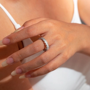 Detailed view of silver titanium steel ring with unique textured industrial pattern on hand