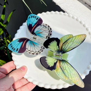 Ethereal butterfly hair claw clips in blue and green acetate with silver spring detail