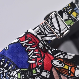 Detail of adjustable metal buckle and cartoon print stitching on canvas baseball cap