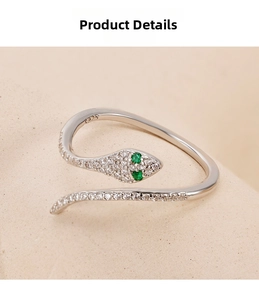 Macro view of S925 sterling silver snake ring with green zircon eyes and white stones