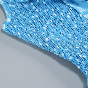 Detail of blue floral dress featuring smocked elastic bodice and delicate woven texture
